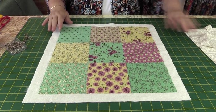 Place the finished square piece on top of the batting, and pin in place.