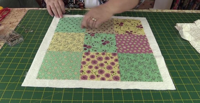 Top stitch diagonal lines across each square to create a cross pattern.