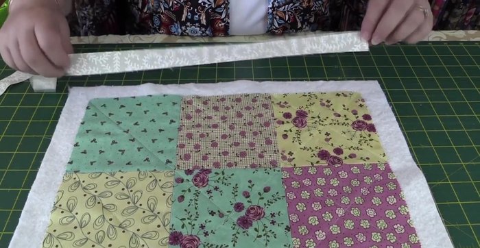 Trim the excess batting, ensuring it aligns with the edges of the squares and border.