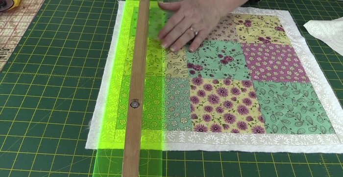 Trim the excess batting, ensuring it aligns with the edges of the squares and border.