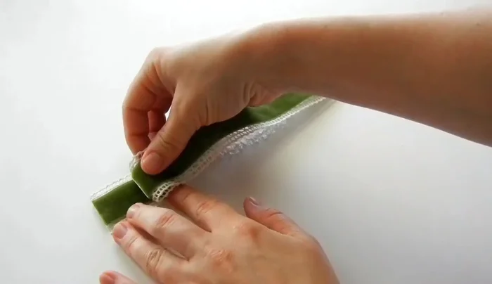 Fold the combined lace and velvet to about one inch, creating the first pleat. Secure with hot glue.