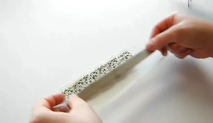 Apply hot glue along the center of the pleats and attach the headband. Optionally, line the back with felt.