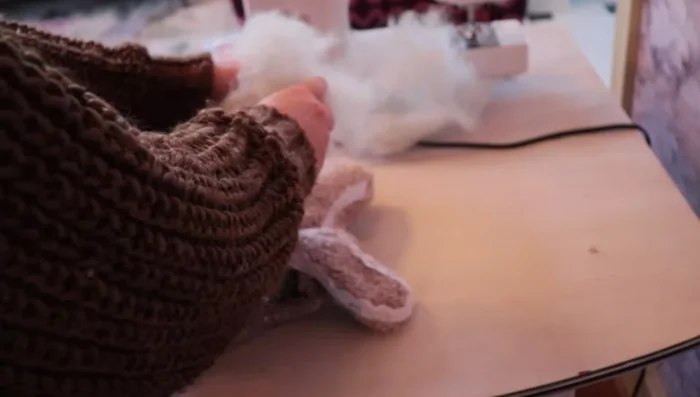 Stuff the pillow with polyfill. Hand-stitch the bottom closed.