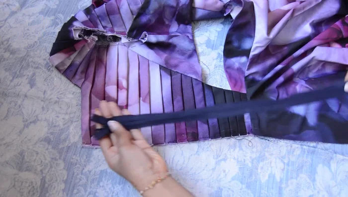 Attach bodice to skirt, add invisible zipper, hem raw edges.