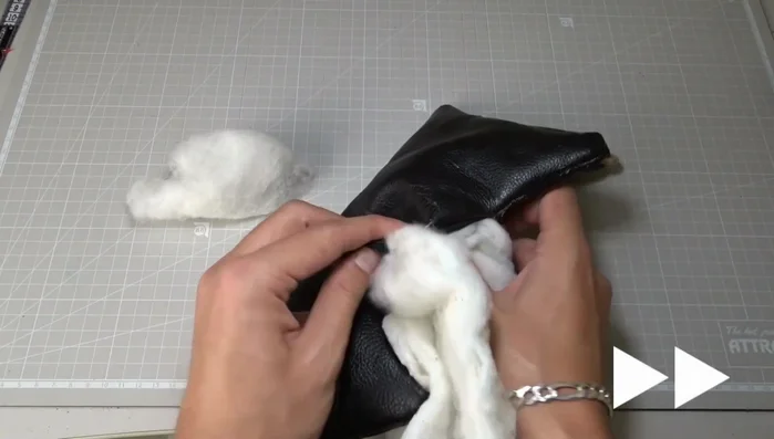 Fill the pillow with stuffing, close the zipper, and tie it securely.