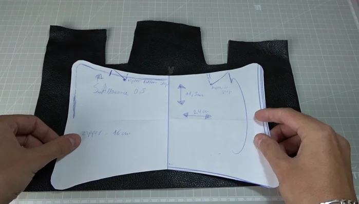 Fold the leather pieces in half and mark the middle with chalk.