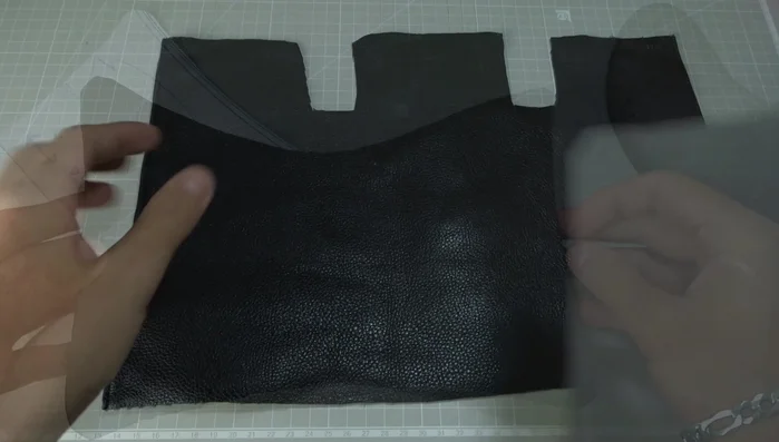Fold the leather pieces in half and mark the middle with chalk.