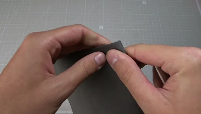 Fold the leather pieces in half and mark the middle with chalk.