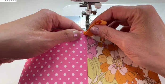 Attach the zipper to one outer fabric piece, centering it and stitching close to the teeth.