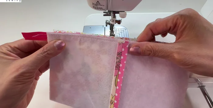 Stitch across the lining and outer fabric, close to the zipper teeth.