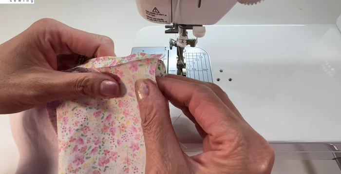 Match the sides of the pouch, fold down seam allowance, and stitch.