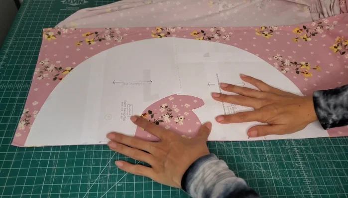 Cut Fabric: Fold fabric, place taped pattern pieces on the fold, and cut around. Use a sharp blade for clean cuts.