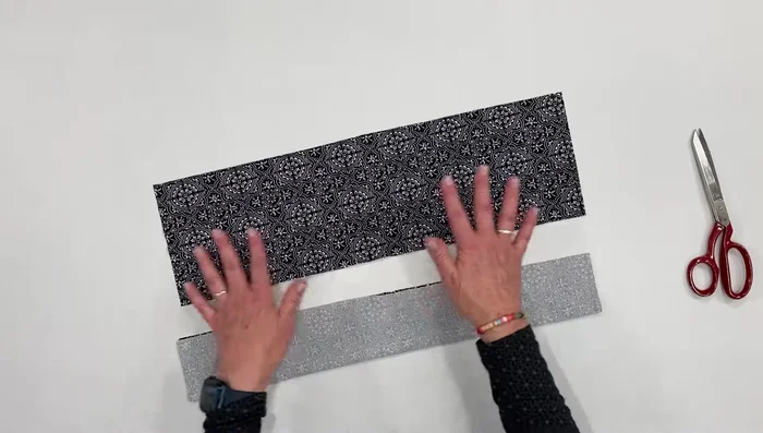 Cut two strips of fabric: 6 inches wide x (head measurement - 2 inches) long.