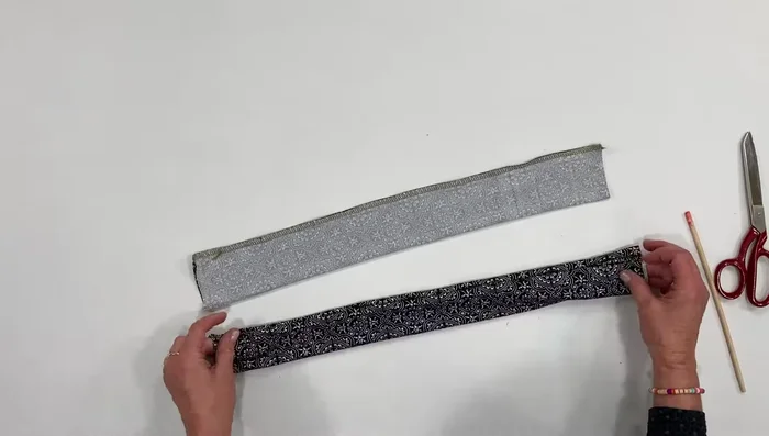 Place the two strips together, seam sides facing each other, and flatten.