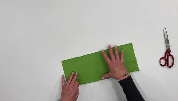 Fold fabric in half lengthwise, right sides together, and sew a seam.