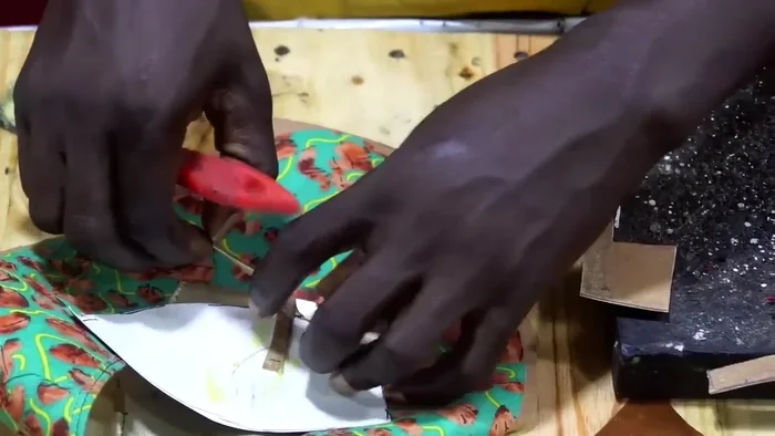 Allow the glue to dry completely. This is emphasized by the music and pause in the video.