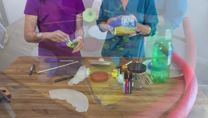 Paint the smaller container and the dowel that will connect the cone to the roof.