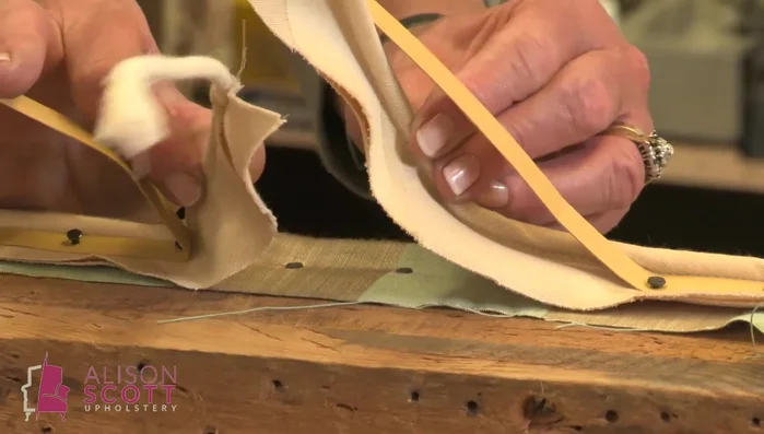 Secure the band around the bottom of the lid using tacks positioned far enough from the edge to be hidden by the lining.