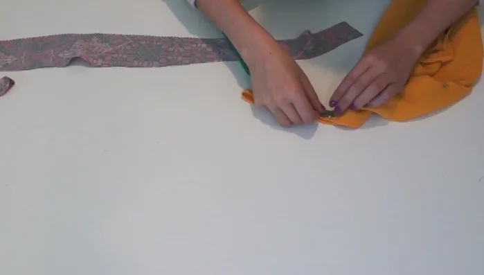 Cut the straps: Measure and cut two 24-inch long and 2-inch wide fabric pieces for the straps.