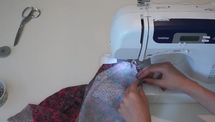 Attach the facing: Pin the facing to the top, right sides together, and sew, leaving a few inches open at the shoulder to insert straps.