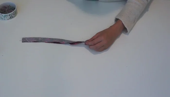 Sew and finish the straps: Fold the straps in half lengthwise, pin, and sew using a serger or sewing machine. Turn right side out, press, and set aside.