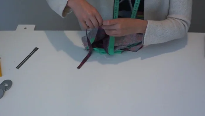 Attach the straps: Insert straps into the openings left at the shoulders. Secure with pins, then try on the cami to adjust strap length if necessary. Re-pin and adjust as needed.