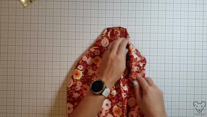 Finish boxed corners: Mark lines 4 inches from the bottom corners to hide raw edges. Sew along the marked lines, trim excess fabric, and press.