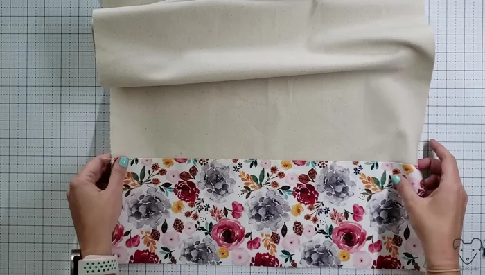 Attach contrasting fabric strips to the base canvas piece using a quarter-inch seam allowance. Top stitch along the contrasting fabric to reinforce the seam.