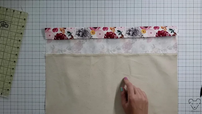 Add lining: Place lining piece right side up, exterior piece right side down (wrong sides together). Tuck the lining under the folded top edge and secure.