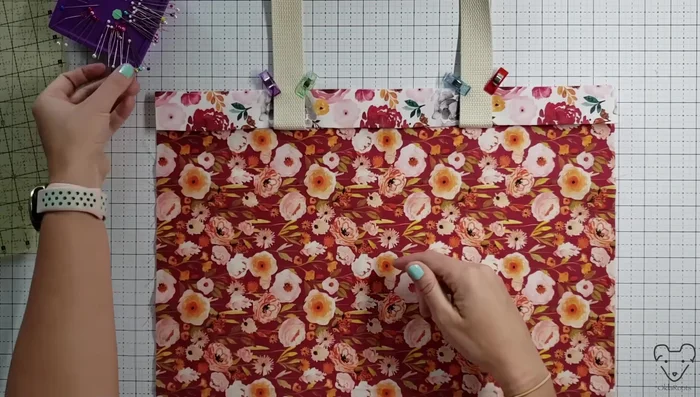 Sew handle attachments: Sew two lines of stitching on each side – one ¼ inch from the top of the fold, and another ¼ inch from the bottom, securing handles.