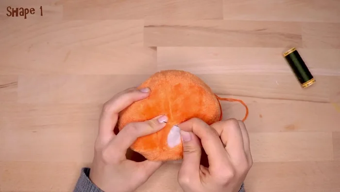 Close the opening with a running stitch using embroidery needle and floss.