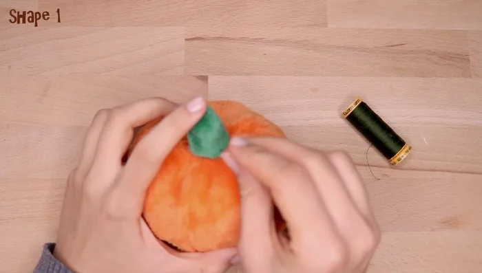 Place it on top of the pumpkin and sew in place.