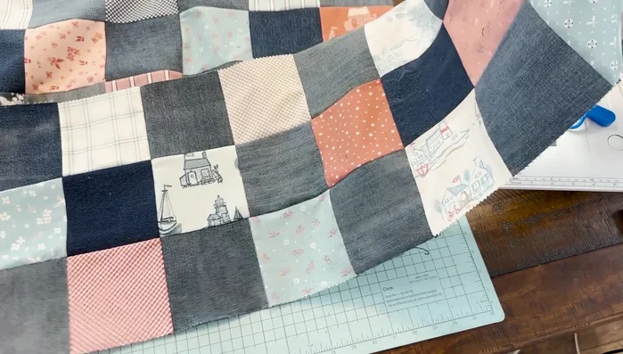 Join rows: Sew the rows together, pressing seams to maintain a flat quilt top.