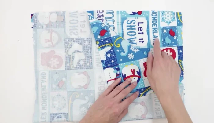 Place the main fabric pieces right sides together, ensuring the fabric direction is correct. Trace or pin the pattern onto the fabric and cut out.