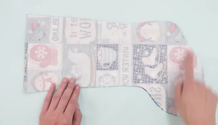 Sew all the way around the sides and bottom of the main fabric pieces with a 3/8 inch seam allowance, leaving the top edge open.