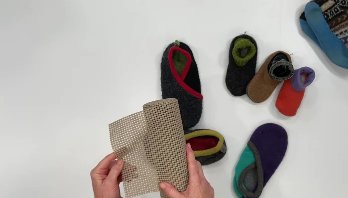 Sew the shelf liner sole onto the slipper or add small pads to the front and heel and zigzag stitch around them.