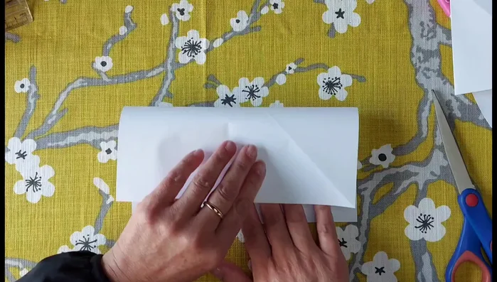 Fold the rectangle in half again to create a smaller square.