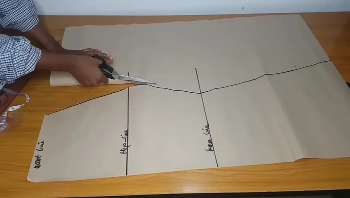 Mark the hip and knee lines on the front pattern pieces for layering. Extend these lines for alignment.