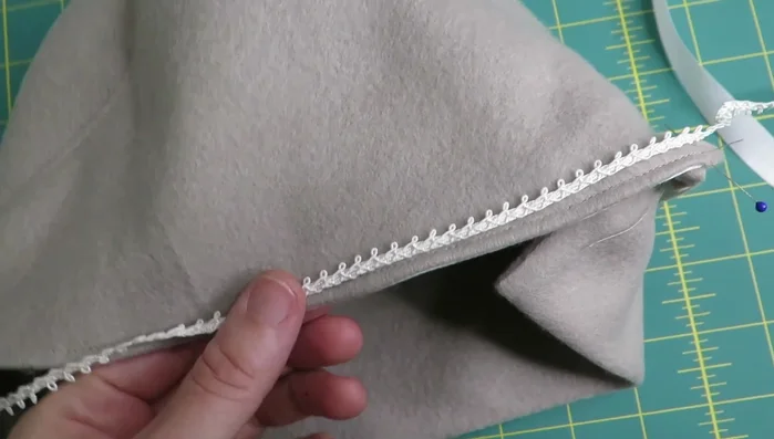 Attach trim to cover the stitch line on the back of the hat.