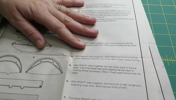 Stitch the hat crown front to the hat top front, matching notches and small dots. Press the seam toward the hat top back.