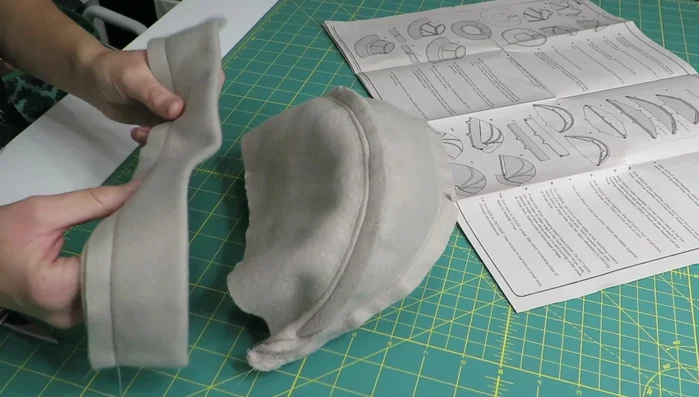 Pin the brim to the lower edge of the hat, matching notches. Stitch, matching centers and large/small dots. Backstitch at large dots.