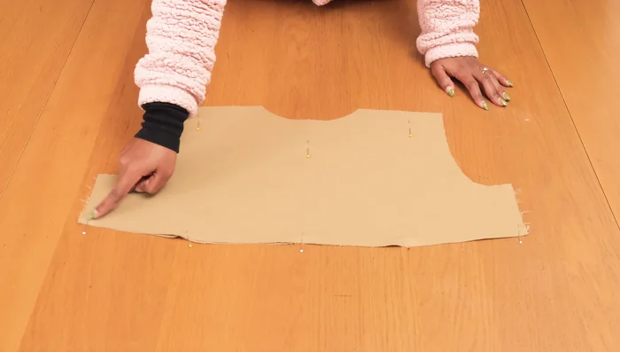 Stitch the storm shield pieces together and attach them to the back of the jacket, incorporating them into the side seams.