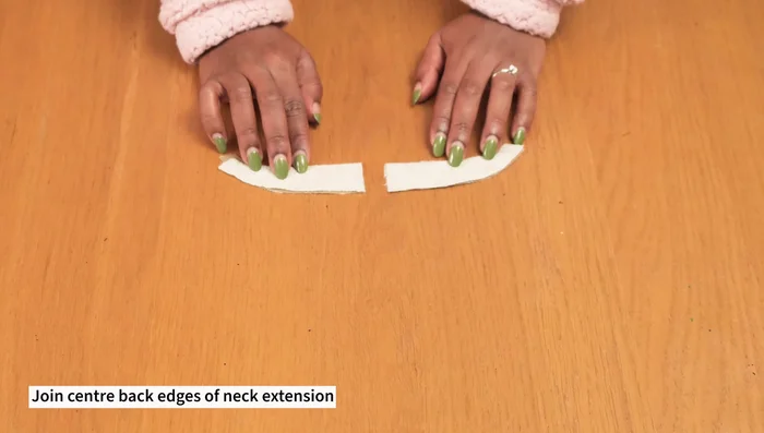 Pin and sew the collar to the jacket neckline, sandwiching it between the jacket and facing. Sew the center front edges, connecting lining to jacket.