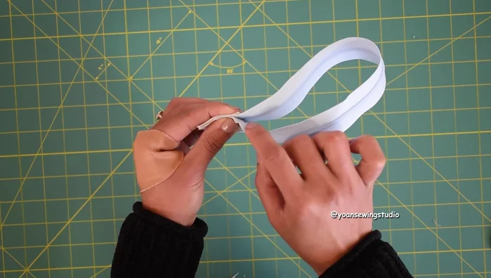 Install the zipper onto the upper panel, then attach the lower panel to complete the front exterior.