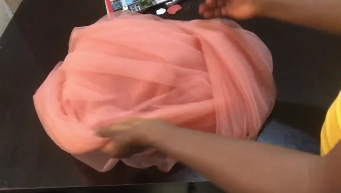 Prepare the net fabric: Fold the net at the desired length. Place small plates under the presser foot to create fullness.