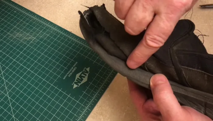 Work your way to the toe of the shoe, stitching back and forth if necessary. Stay close to the rubber sole.