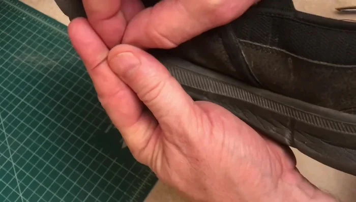 Work your way to the toe of the shoe, stitching back and forth if necessary. Stay close to the rubber sole.