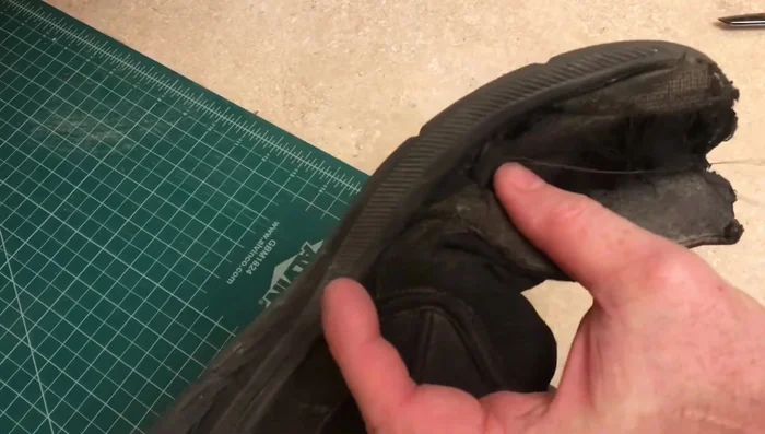 Work your way to the toe of the shoe, stitching back and forth if necessary. Stay close to the rubber sole.
