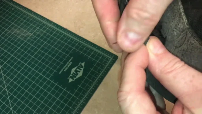 Work your way to the toe of the shoe, stitching back and forth if necessary. Stay close to the rubber sole.