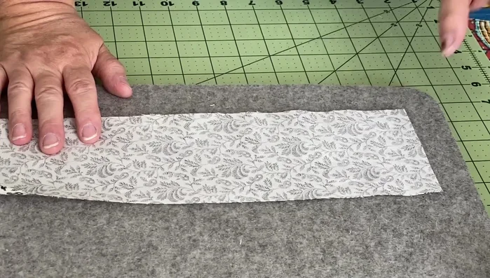 Iron the handles. If attaching to the seams, no need for French hems. If attaching externally, create a French hem.